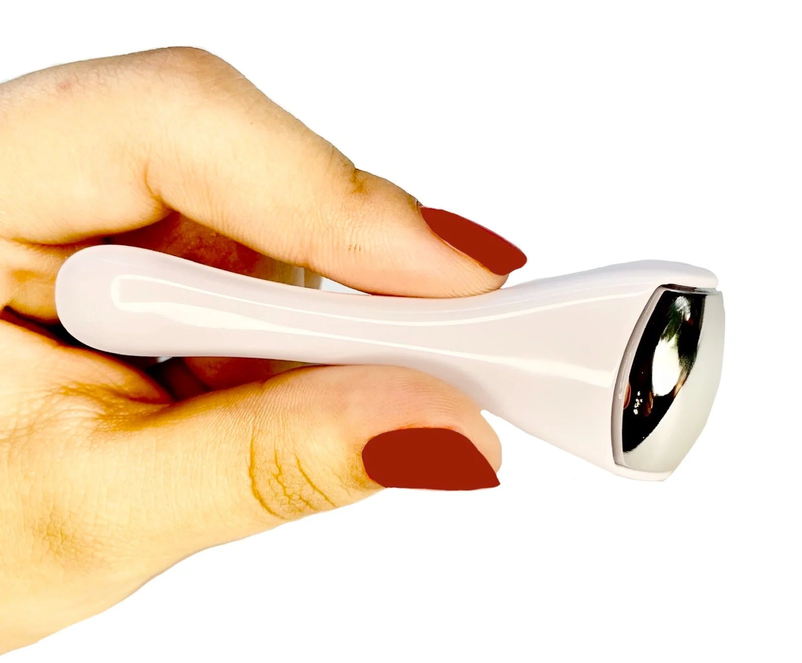 Ice roller gliding across the cheek to de-puff facial skin